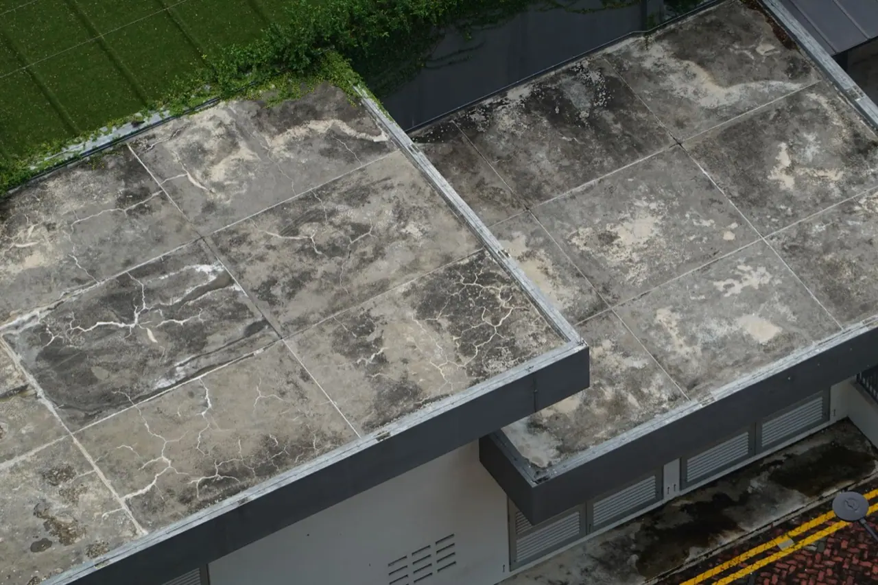 Weathered and stained flat roofs on older buildings