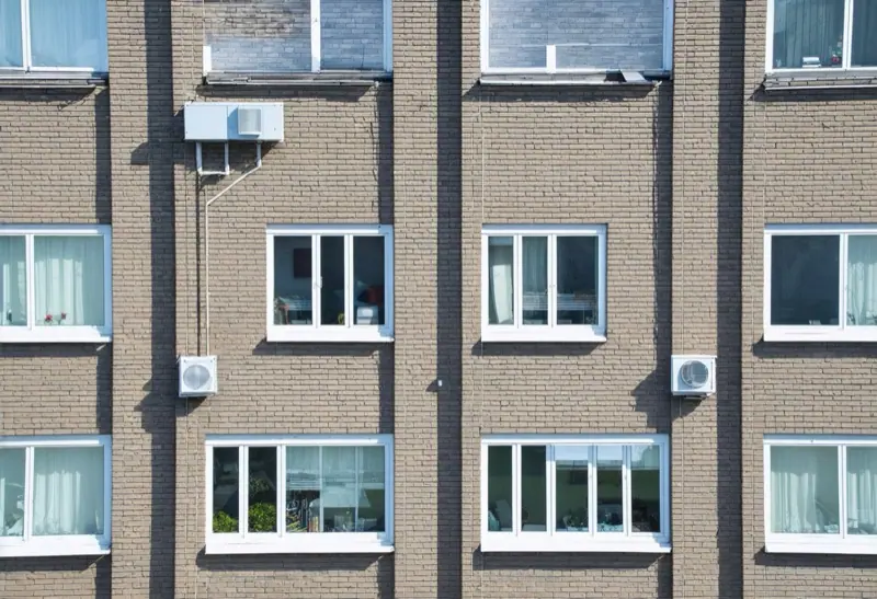 Brick low-rise apartment building with wall air conditioners