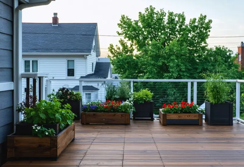 Rooftop terrace with wood decking, planters and a glass railing